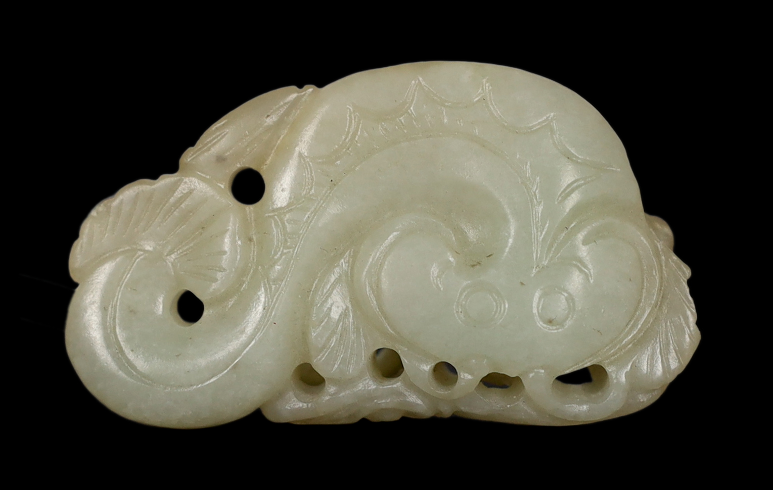 A Chinese pale celadon jade carving of a stylised catfish, probably 17th century